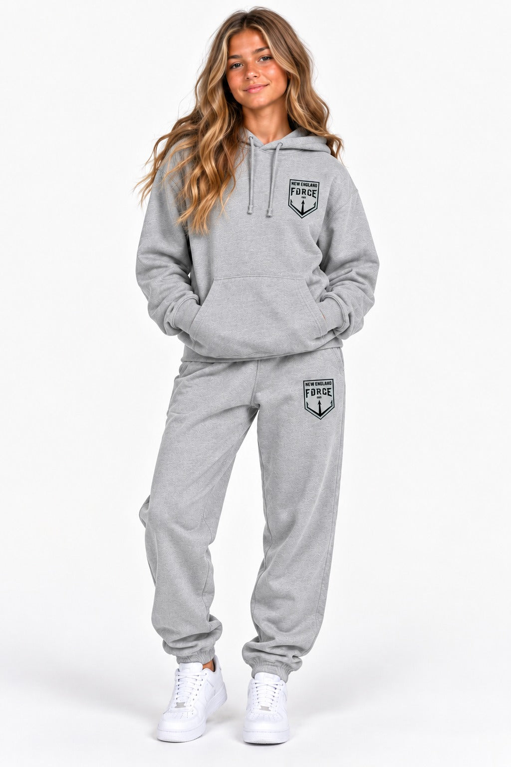 New England Force hoodie and sweatpants set in gray with black crest, worn by a girl