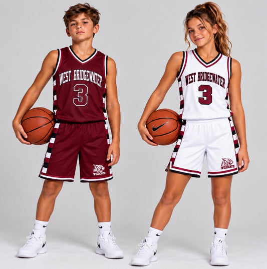 Two youth basketball players in matching custom reversible uniforms, one showing the maroon side and one the white side, each holding a basketball